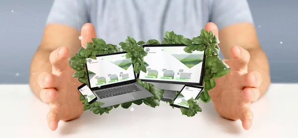 Businessman holding a Connected devices surrounding by leaves 3d