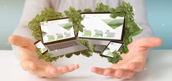 Businessman holding a Connected devices surrounding by leaves 3d