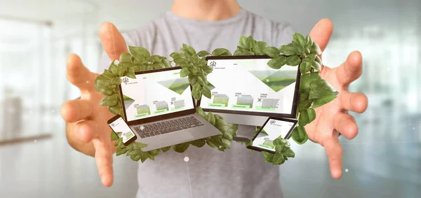 Businessman holding a Connected devices surrounding by leaves 3d