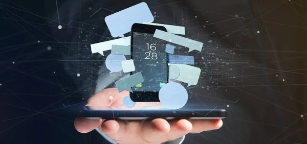 Бизнесмен держит пузыри сообщений, окружающие смартфон — стоковое фото