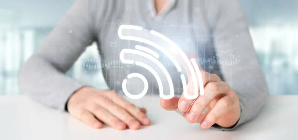 Geschäftsmann hält ein Wifi-Symbol mit Daten rundherum — Stockfoto