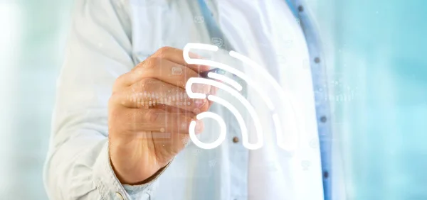 Geschäftsmann hält ein Wifi-Symbol mit Daten rundherum — Stockfoto