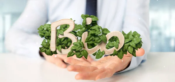 Empresario sosteniendo logotipo de madera bio con hojas alrededor de 3d render —  Fotos de Stock
