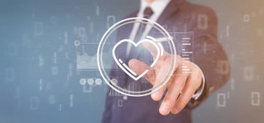 Veri ile çevrili bir kalp simgesi tutan işadamı