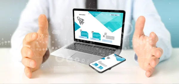Empresário segurando um laptop e um smartphone - renderização 3d — Fotografia de Stock