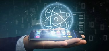 Veri ile çevrili bir atom simgesi tutan işadamı