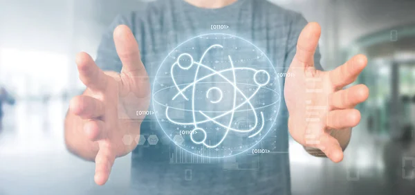 Empresario sosteniendo un icono de átomo rodeado de datos —  Fotos de Stock