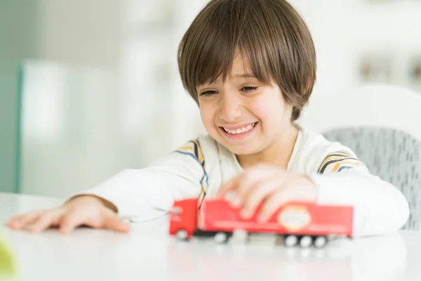 Boy playing with no name truck toy — Stock Photo, Image