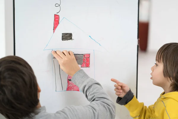 Little boy at home drawing and playing — Stock Photo, Image