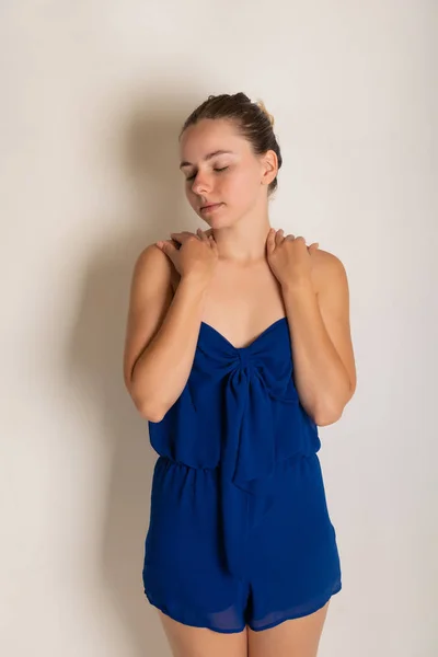 Pretty petite brunette in a blue romper dress