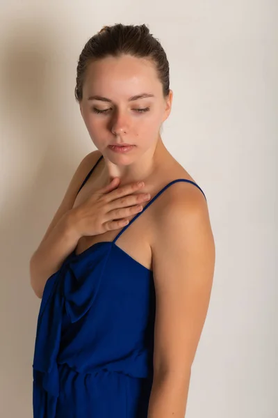 Pretty petite brunette in a blue romper dress