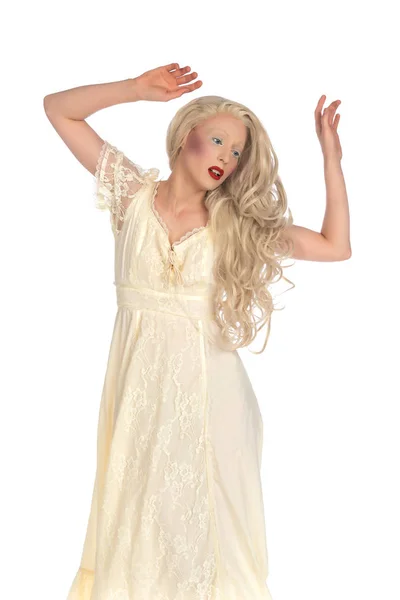 Pale young blonde woman in a yellow dress