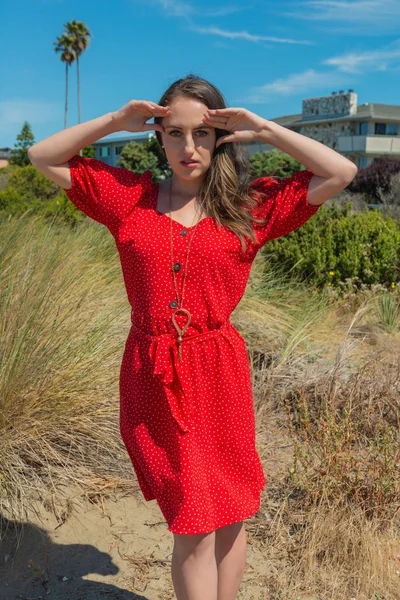 Morena em vermelho em uma praia — Fotografia de Stock
