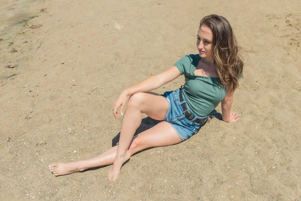 Brunette in teal and blue on a beach — Stock Photo, Image