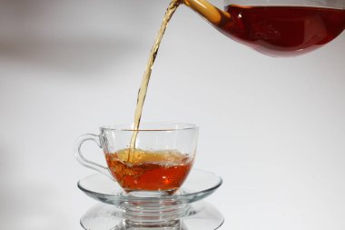 Çay fincanına çay dolduruyorum..