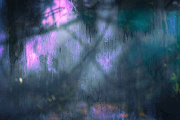 Old dirty dusty window glass with mystical reflection. Soft focus. Abstract background with scratches. Blue and pink color.