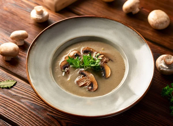 mushrooms soup on wooden kitchen, close  view