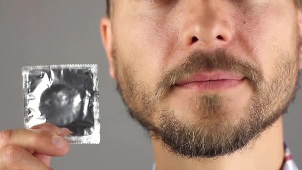 Hombre Con Barba Bigote Tiene Nuevo Condón Mano Cerca Cara — Vídeos de Stock