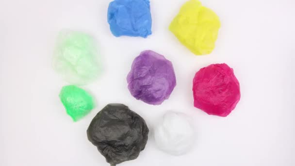 Crumpled Ball Used Plastic Bags Different Colors Rotates White Background — Stock Video