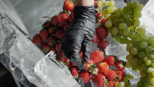 Fresh, clean strawberries, grapes and other fruits without preservatives and chemicals on ice 4k Slow motion camera rotation — Stock Video