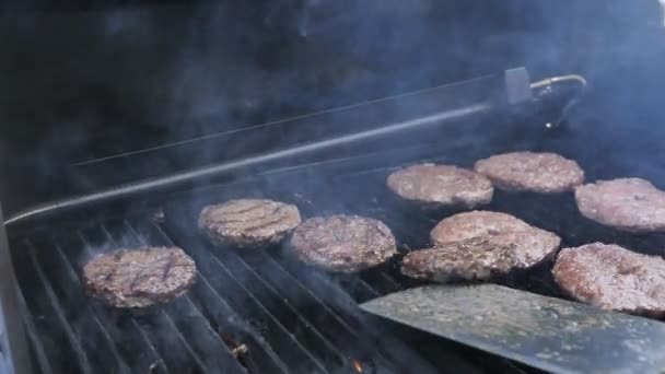 Burger cutlet cooked on a grill tossed to the top, a flame appears Slow motion 180 fps — Stock Video