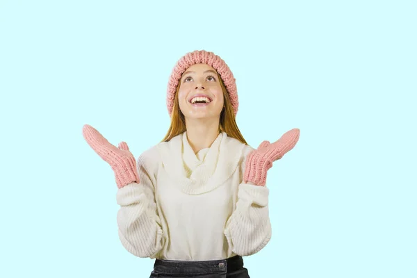 Attractive young red-haired girl, stares in surprise and points her hands up to the free space on an isolated background — Stock Photo, Image