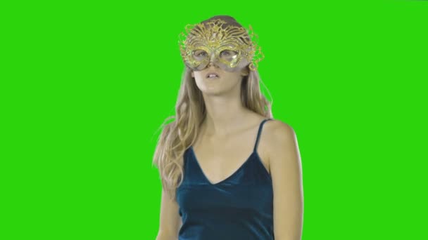 Young beautiful girl with long wavy curls in evening dress and carnival mask expresses pleasant emotions, emotions of happiness, emotions of pleasure, mysterious look — Stock videók