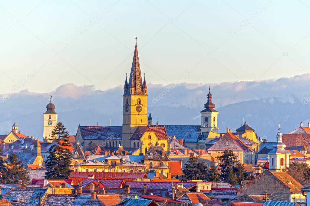 Sibiu, Transylvania, Romania, cityscape in winter with Carpathians mountains in background