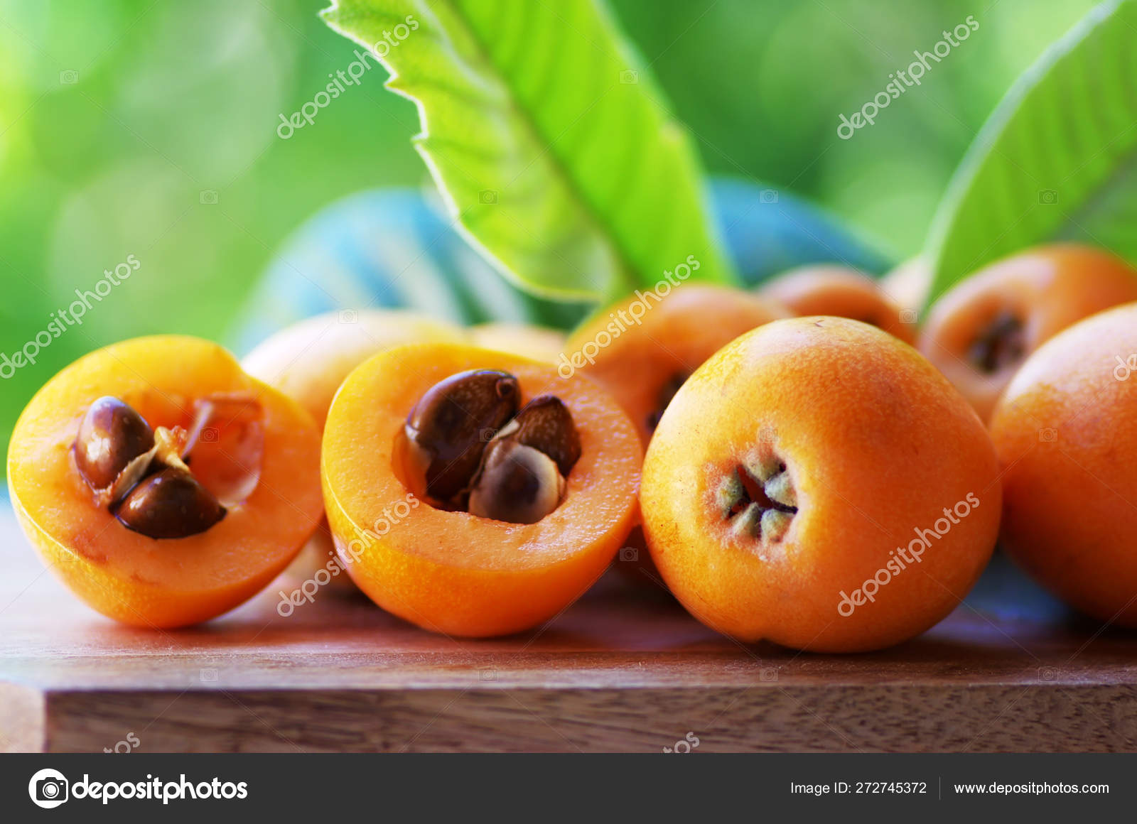 Loquat Medlar fruit isolated on a green background Stock Photo by