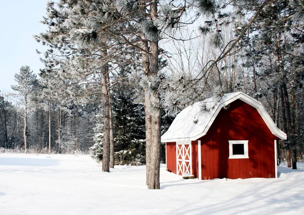 Red barn on a winter background