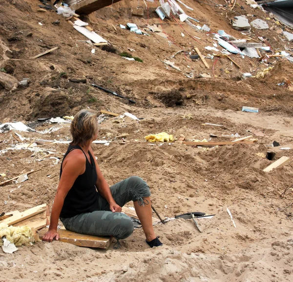 Woman looking at storm damage — Stock Photo, Image