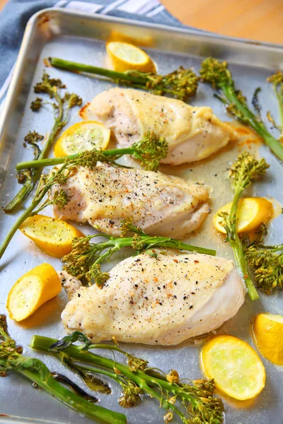 Dinner of baked chicken breasts with squash and broccolini
