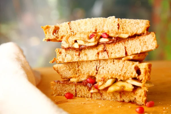 Closeup Stacked Sandwich Peanut Butter Chocolate Spread Pomegranate Seeds Cinnamon — Stock Photo, Image