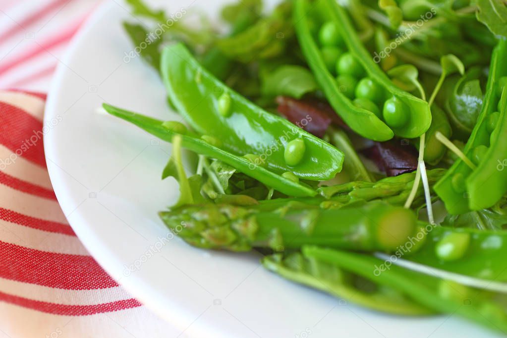 Fresh snap peas and asparagus in a spring salad