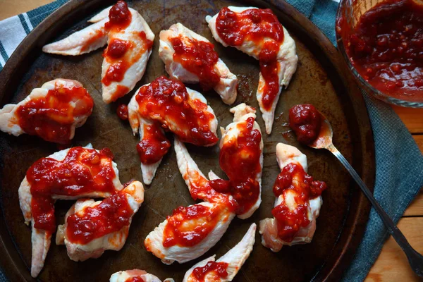 Overhead view of chicken wings ready to bak