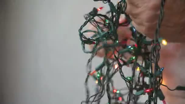 Profile View Man Trying Untangle String Multi Colored Christmas Lights — Stock Video