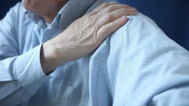 İşadamı acılı omzuna masaj yapıyor