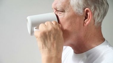 Yaşlı bir adam sabah kahvesini içer..