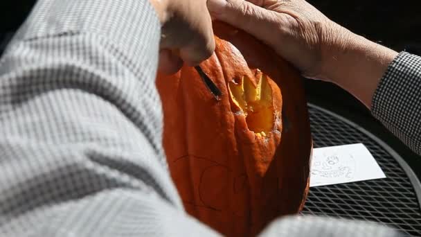 Using Carving Tools Cut Out Features Jack Lantern — Stock Video