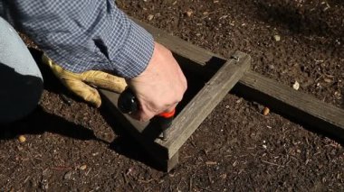 Bir adam bir vida kaldırmak için bir matkap kullanır