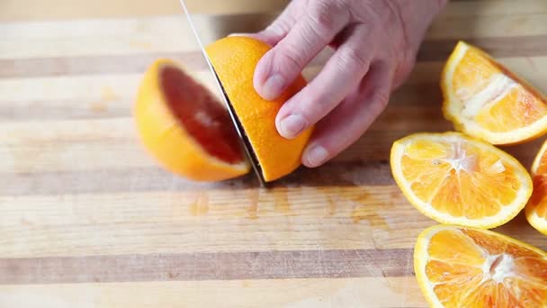 Man Prepares Blood Oranges Cutting Board — Stock Video