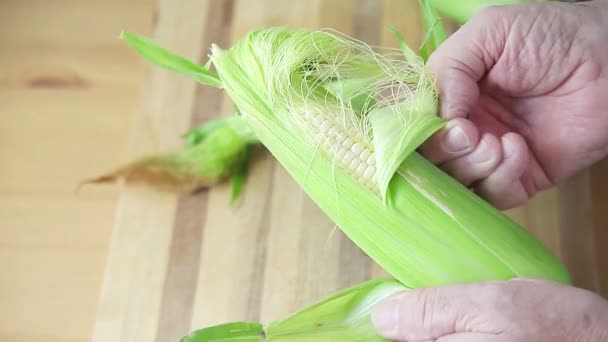 Older Man Pulls Husk Corn Cutting Board — Stock Video