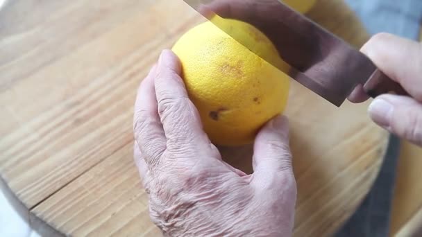 Senior Man Cuts Fresh Grapefruit Two — Stock Video