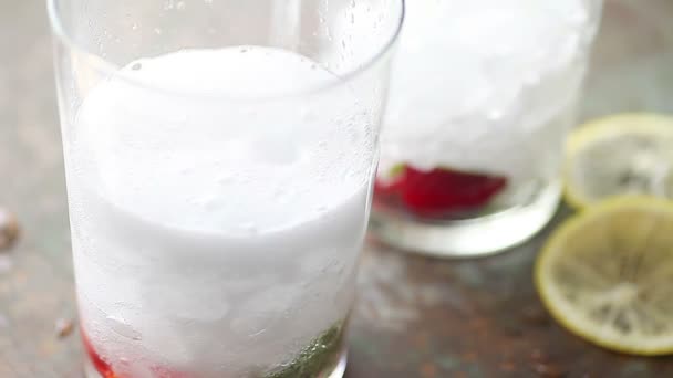 Adding Carbonated Water Glasses Strawberries Mint Crushed Ice — Stock Video