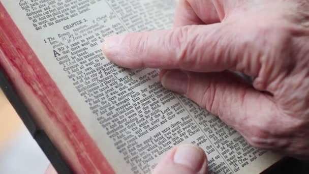 Older Man Holds Vintage Bible Uses His Index Finger Track — Stock Video