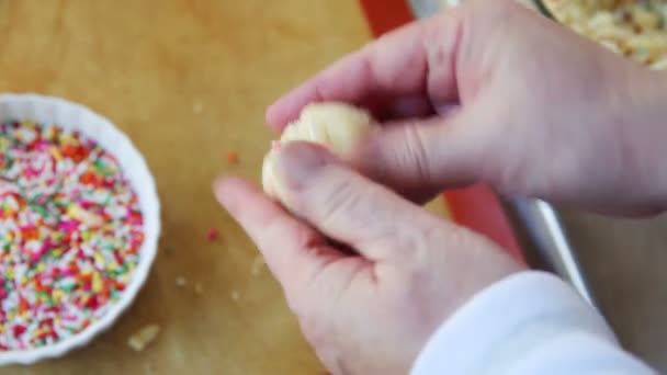 Woman Forms Cookie Balls Rolling Them Colorful Sprinkles — Stock Video