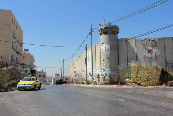STATE OF PALESTINE, BETHLEHEM, SEPTEMBER 15, 2010: Taxi car near security wall in Bethlehem, State of Palestine