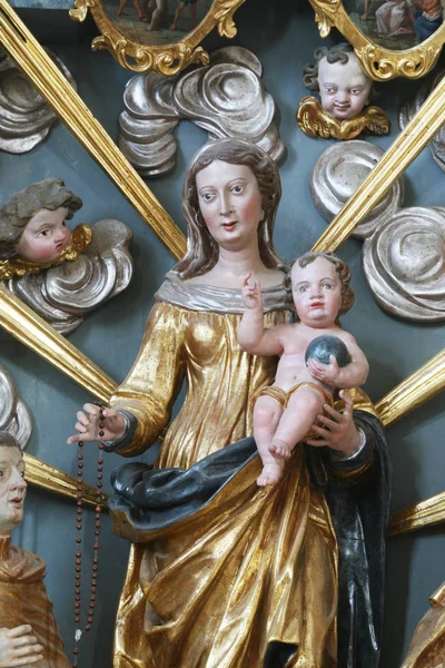 Our Lady Queen of the Rosary statue on the altar in the Baroque Church of Our Lady of the Snow in Belec, Croatia