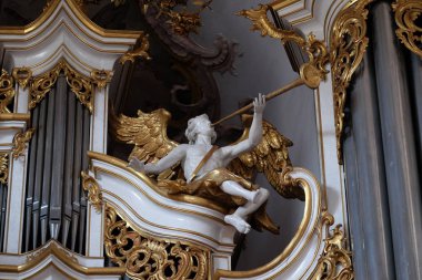 Angel statue on the organ in Amorbach Benedictine monastery church in the district of Miltenberg in Lower Franconia in Bavaria, Germany clipart