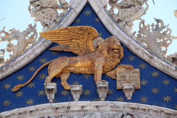 Golden winged lion, symbol of Venice on the Basilica of St. Mark on Piazza San Marco, Venice, Italy, UNESCO World Heritage Site